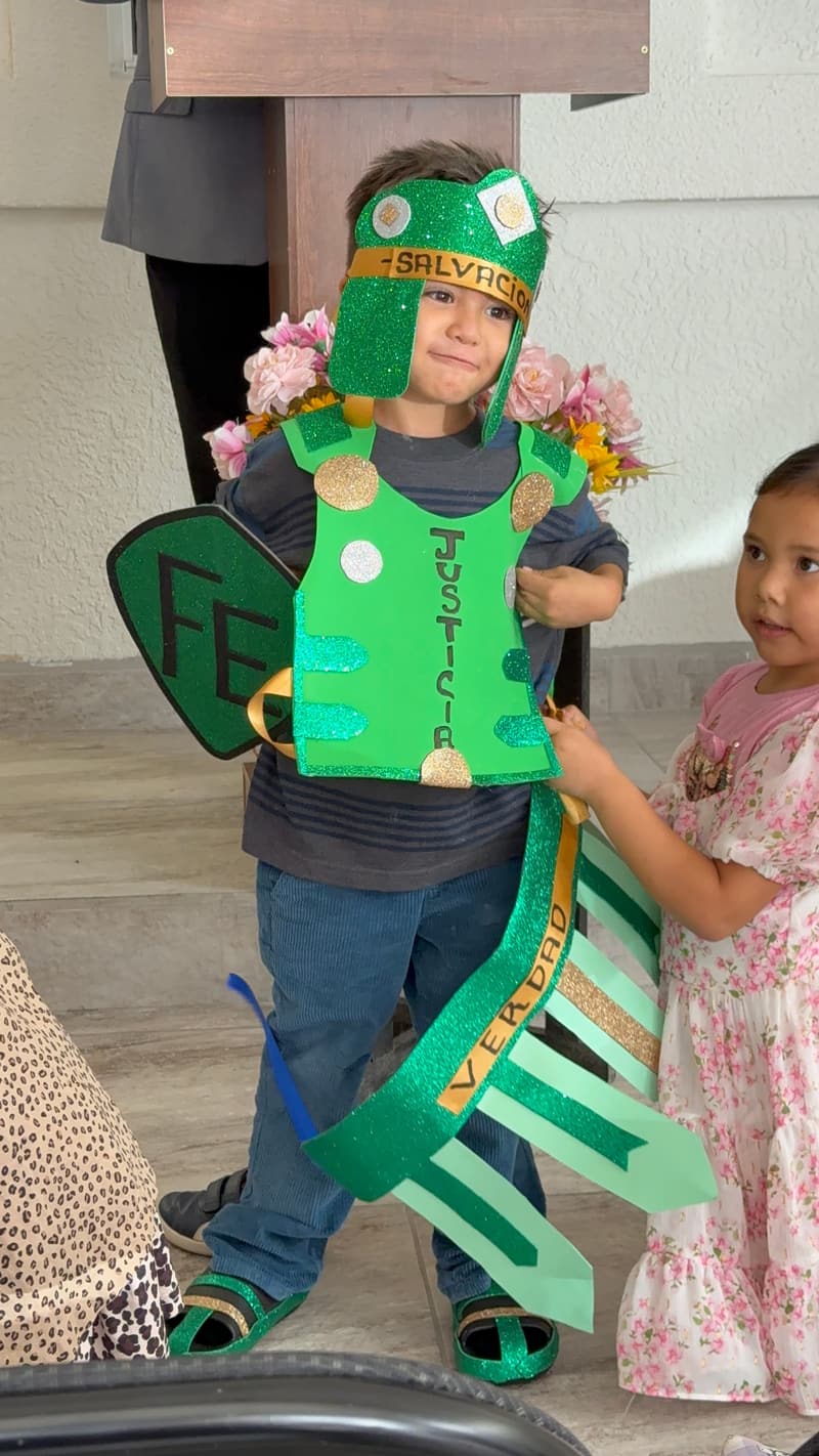 A child wearing a paper armor of God costume with a helmet, shield and sword at the Tijuana church.